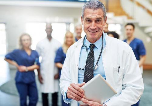 Adult man in doc uniform with tablet